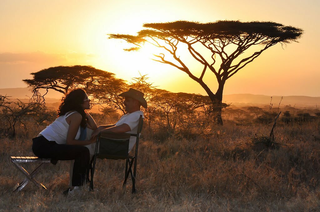 bridal couple sitting with sunset